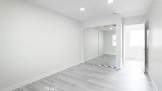 an empty room with wooden floor