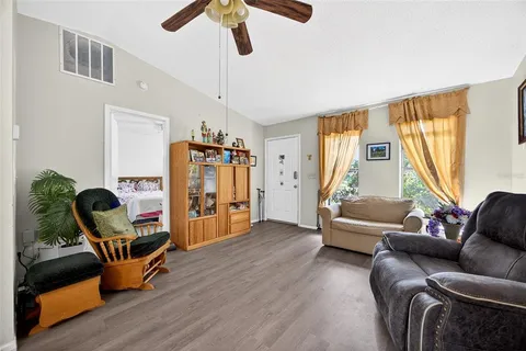 a living room with furniture and a wooden floor