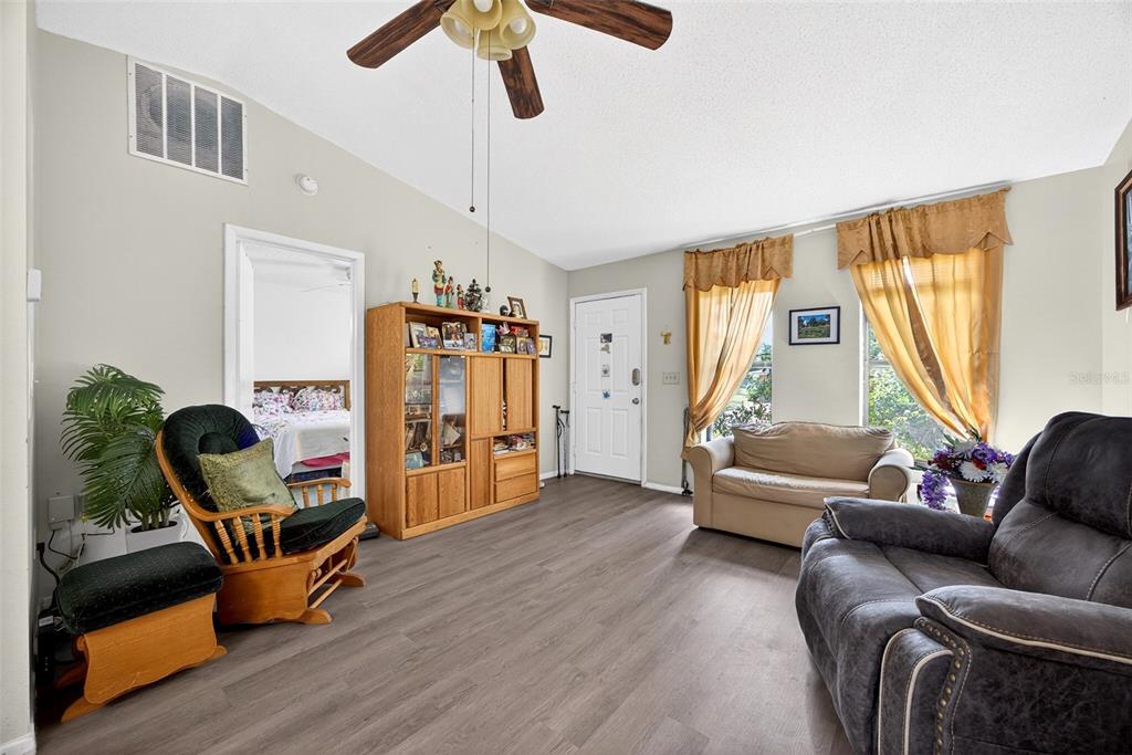 464 Coronado Road Venice, FL 34293 - Photo 2 of 28 a living room with furniture and a wooden floor