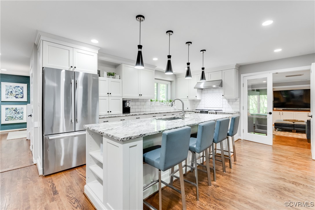 3510 Lansdowne Road Midlothian, VA 23113 - Photo 20 of 47 a kitchen with stainless steel appliances kitchen island granite countertop a refrigerator and a stove top oven