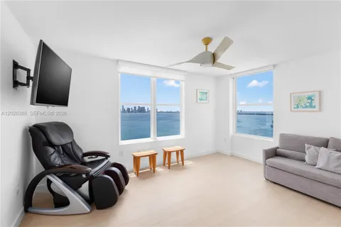 a view of a livingroom with workspace and a flat screen tv