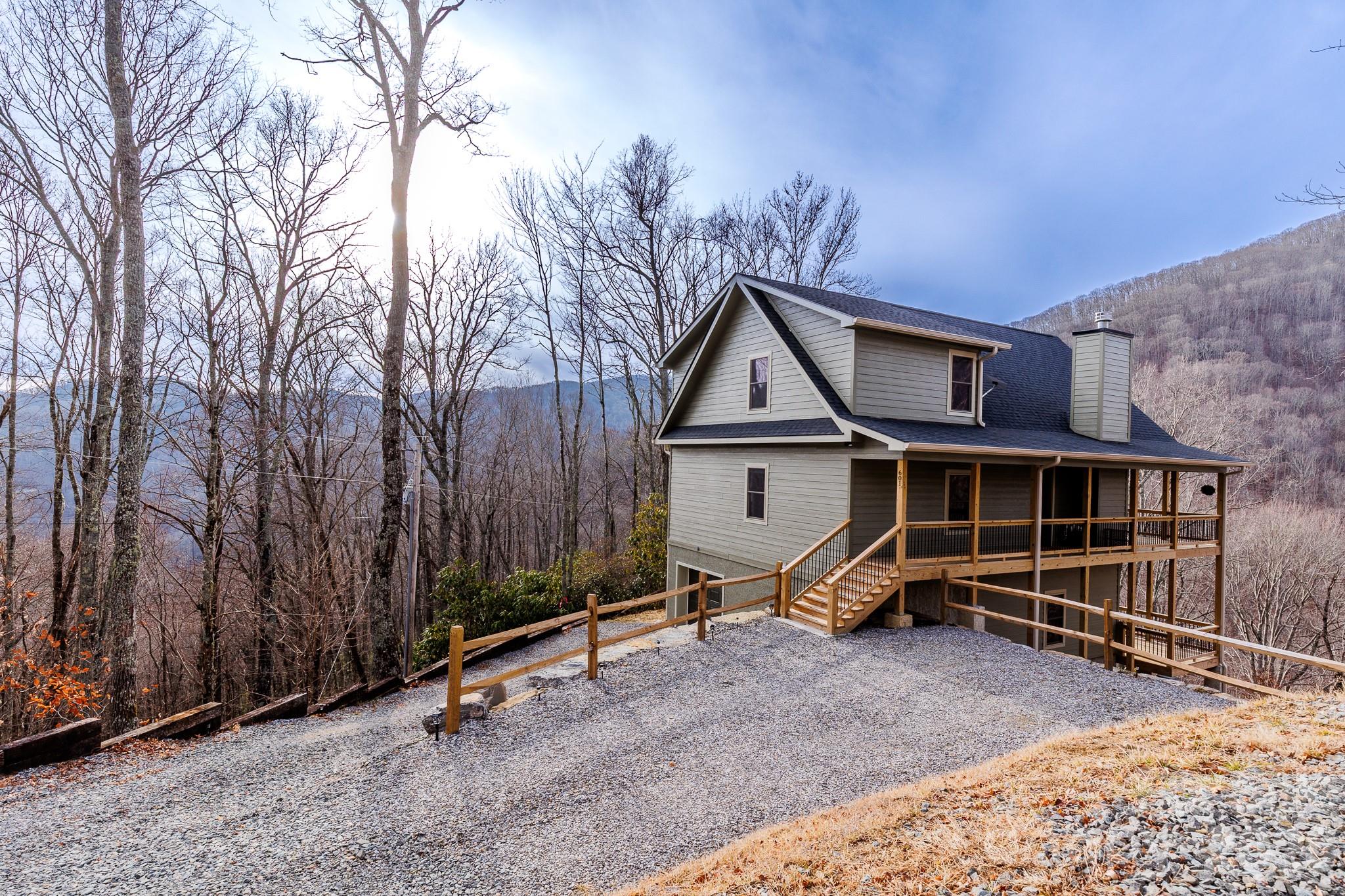 601 Tater Patch Road Maggie Valley, NC 28751 - Photo 1 of 32 a view of a house with a yard and wooden fence