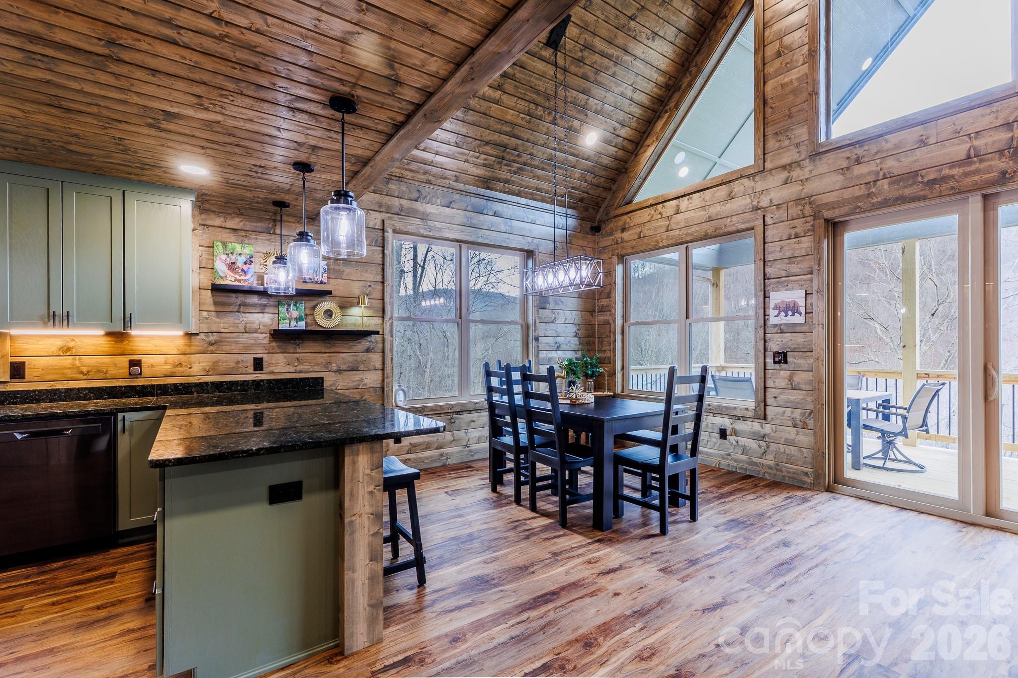 601 Tater Patch Road Maggie Valley, NC 28751 - Photo 13 of 32 a kitchen with lots of counter top space and dining table