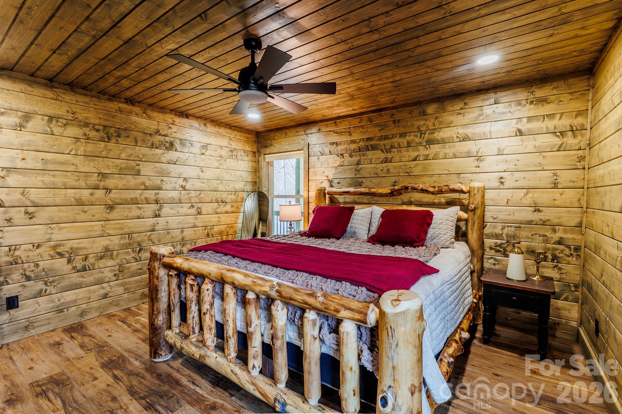 601 Tater Patch Road Maggie Valley, NC 28751 - Photo 21 of 32 a bedroom with a bed and a table