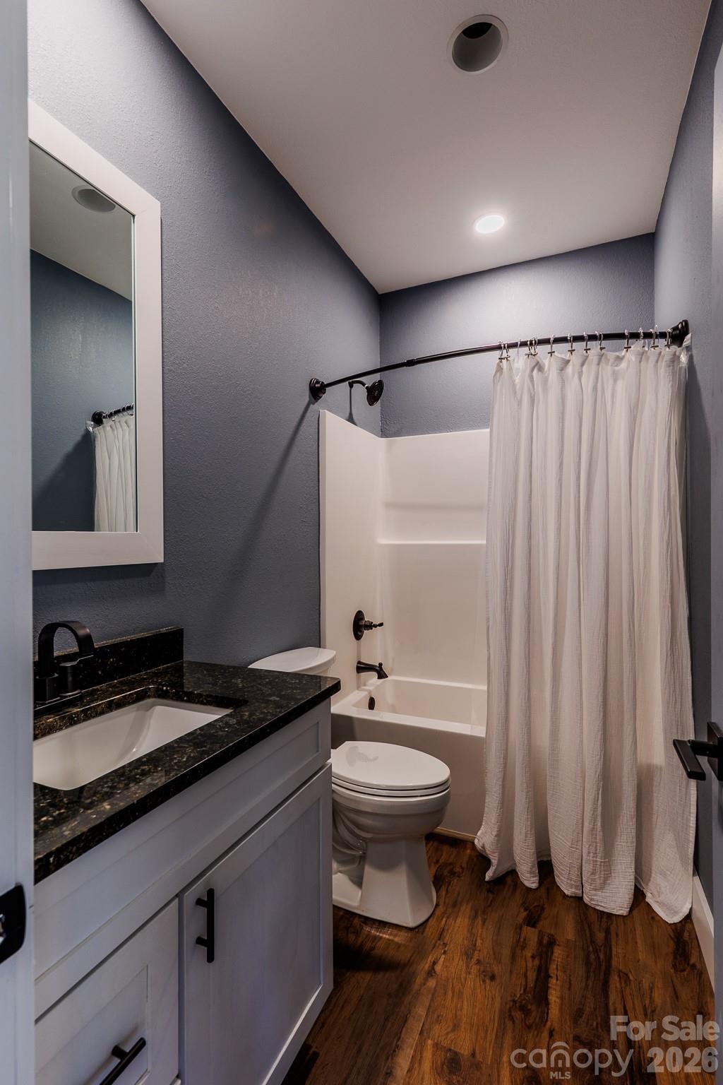 601 Tater Patch Road Maggie Valley, NC 28751 - Photo 26 of 32 a bathroom with a granite countertop sink toilet and shower