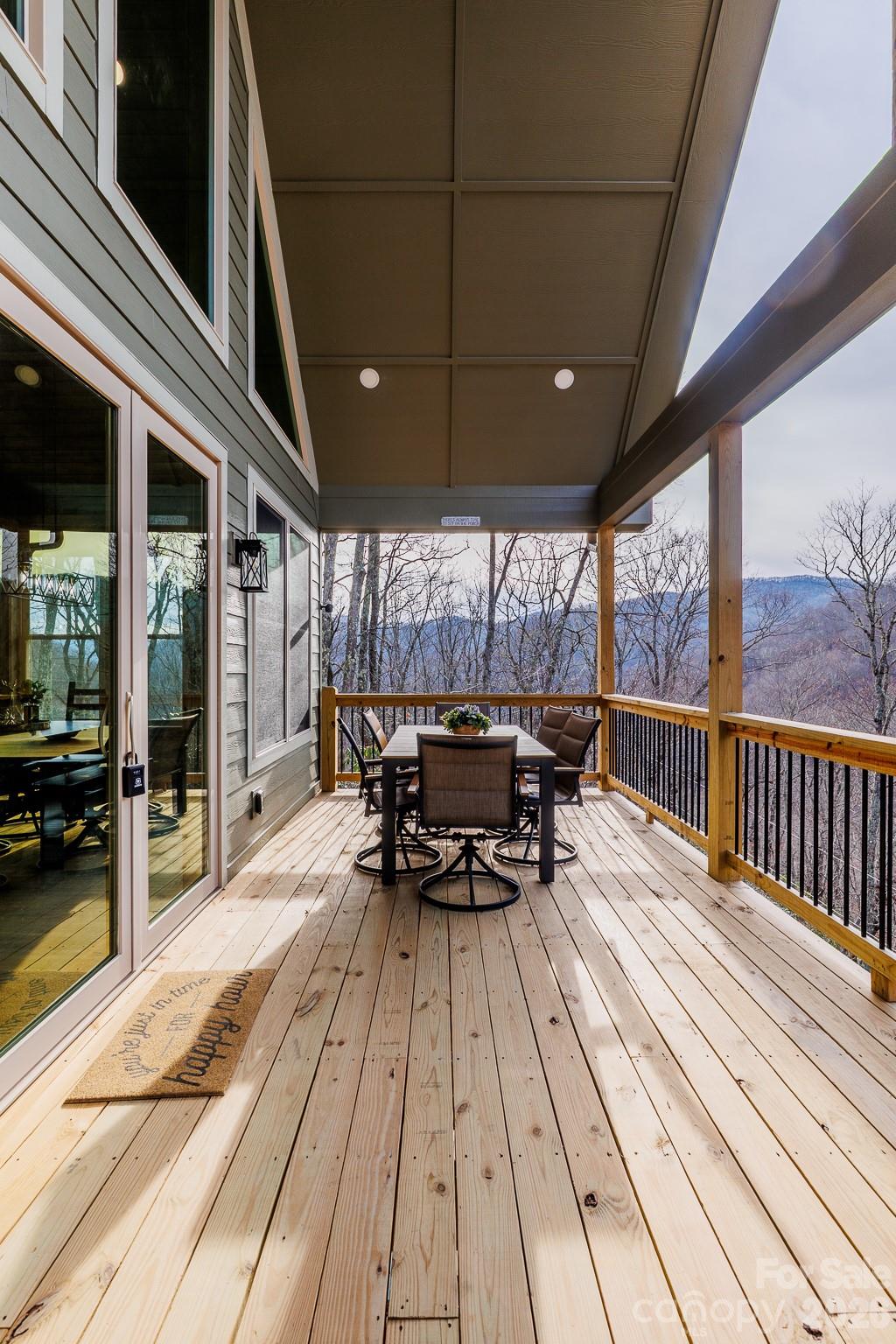 601 Tater Patch Road Maggie Valley, NC 28751 - Photo 5 of 32 a view of a patio with table and chairs wooden floor