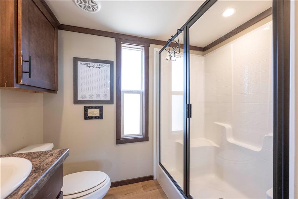 192 Mountain Road Morganton, GA 30560 - Photo 17 of 42 a bathroom with a granite countertop bathtub shower sink mirror vanity and toilet
