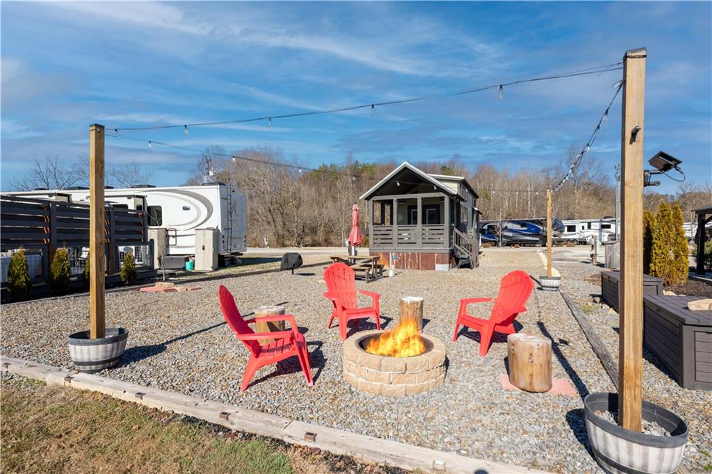 192 Mountain Road Morganton, GA 30560 - Photo 25 of 42 a view of a patio with a dining table and chairs
