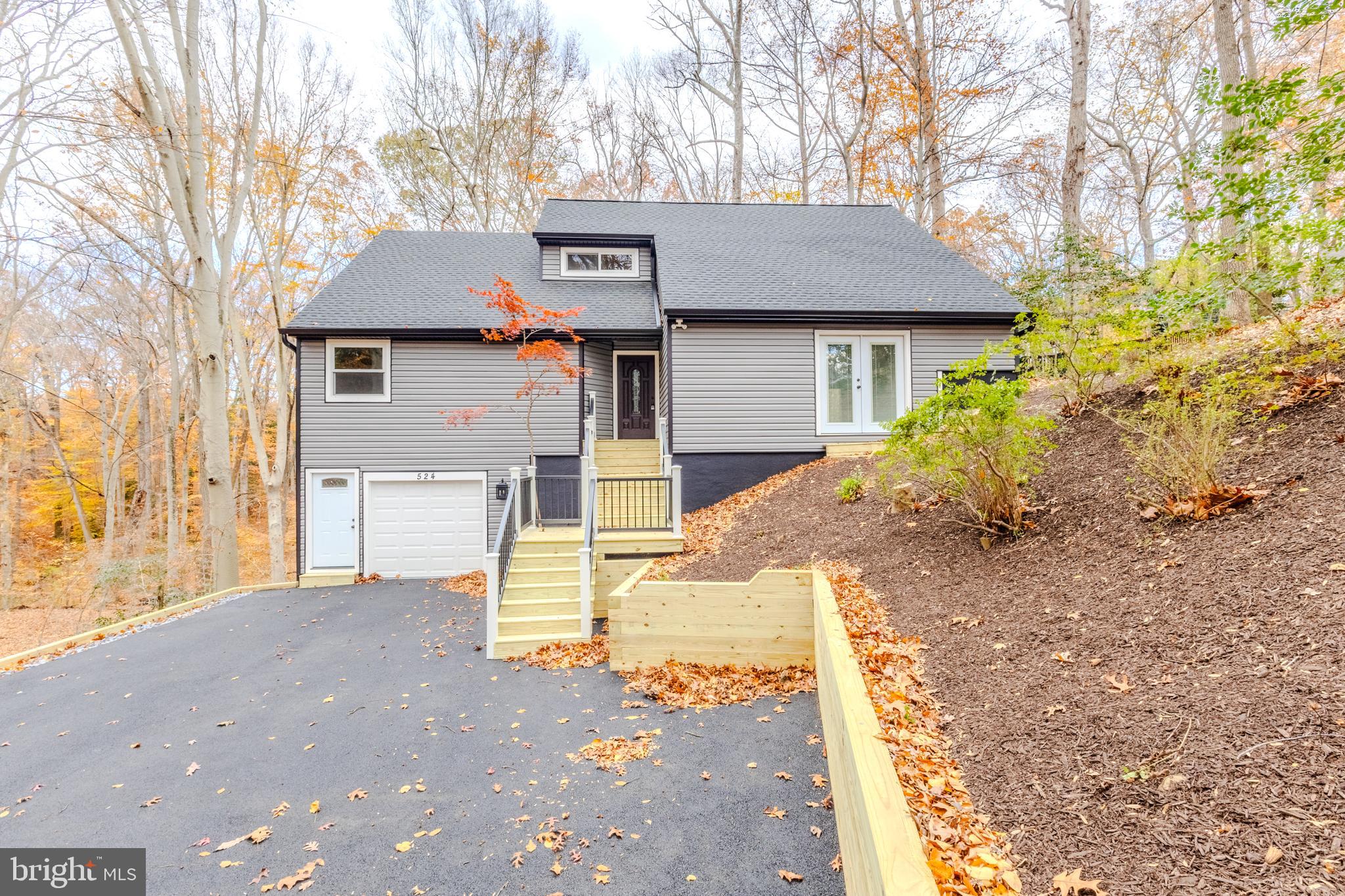 524 Ridge Road Annapolis, MD 21401 - Photo 2 of 53 a front view of a house with a yard and garage