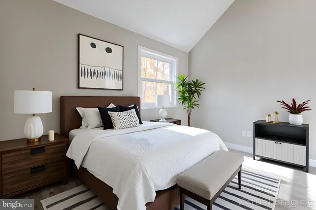 a view of an empty room with wooden floor and closet