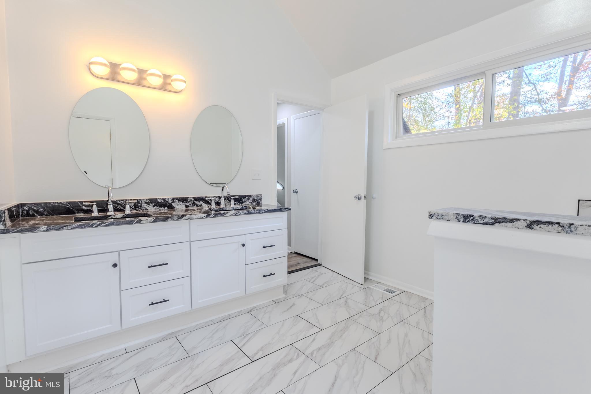 524 Ridge Road Annapolis, MD 21401 - Photo 35 of 53 a spacious bathroom with a double vanity sink and a mirror