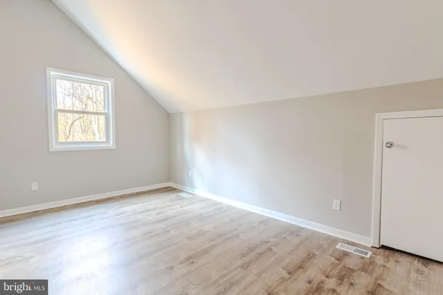 a view of a workspace with furniture and window in a room