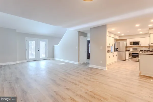 a kitchen with granite countertop a sink stove and cabinets