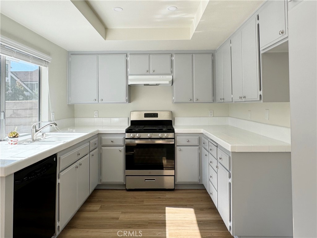 49 Summerstone Irvine, CA 92614 - Photo 2 of 28 a kitchen with a sink and cabinets