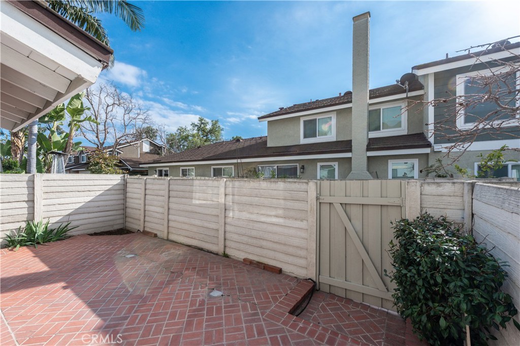 49 Summerstone Irvine, CA 92614 - Photo 24 of 28 a view of a house with a wooden fence
