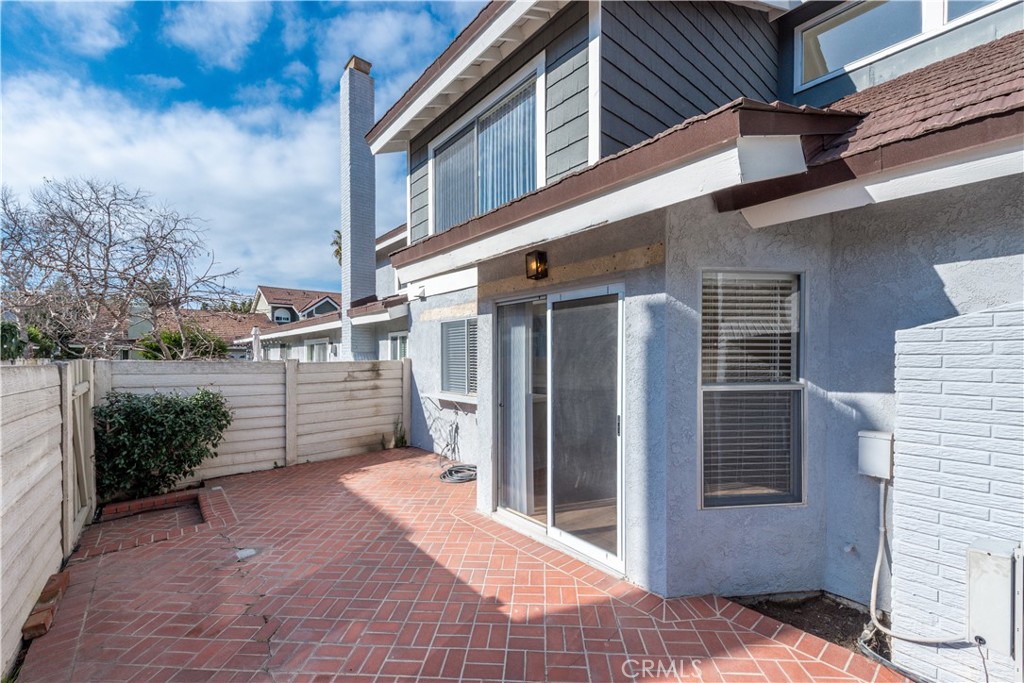 49 Summerstone Irvine, CA 92614 - Photo 26 of 28 a view of a house with a door and wooden fence