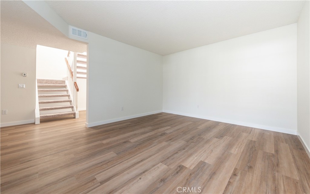 49 Summerstone Irvine, CA 92614 - Photo 5 of 28 a view of a room with wooden floor and white walls