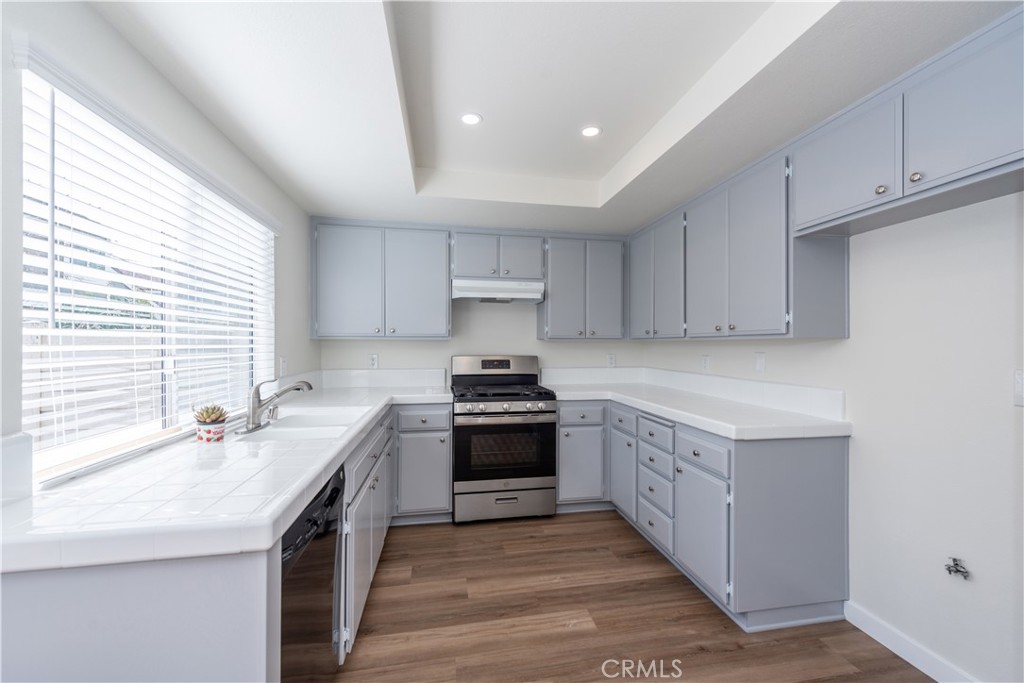 49 Summerstone Irvine, CA 92614 - Photo 9 of 28 a kitchen with stainless steel appliances granite countertop a sink stove and cabinets