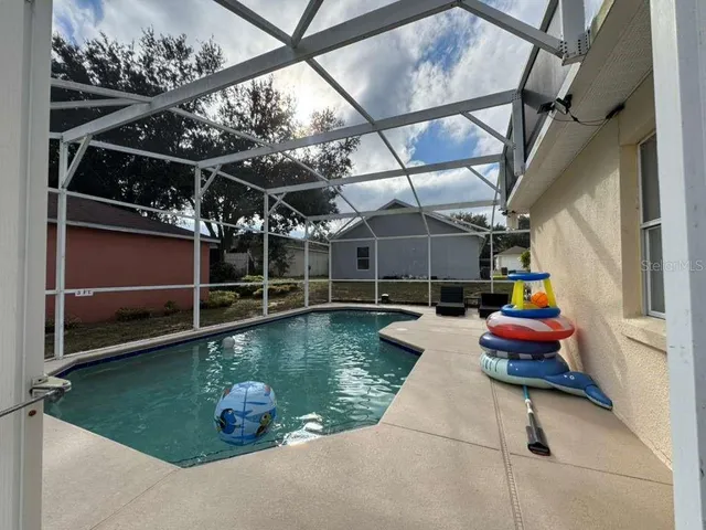 a view of a swimming pool with a yard