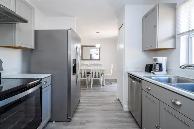 a bedroom with a bed and a lamp on the dresser