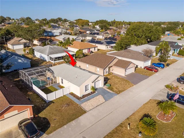 an aerial view of a house with a yard