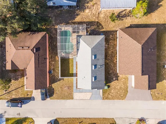 an aerial view of a house with a mountain view