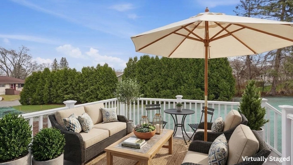 105 Stafford Road Lowell, MA 01852 - Photo 31 of 42 a view of a roof deck with furniture and a umbrella