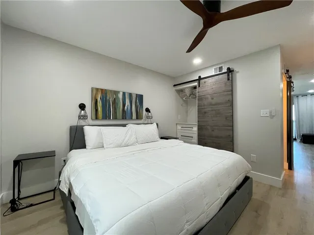 a spacious bathroom with a double vanity sink a mirror and shower