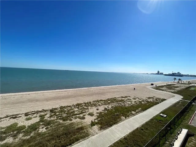 a living room with a couch and a refrigerator