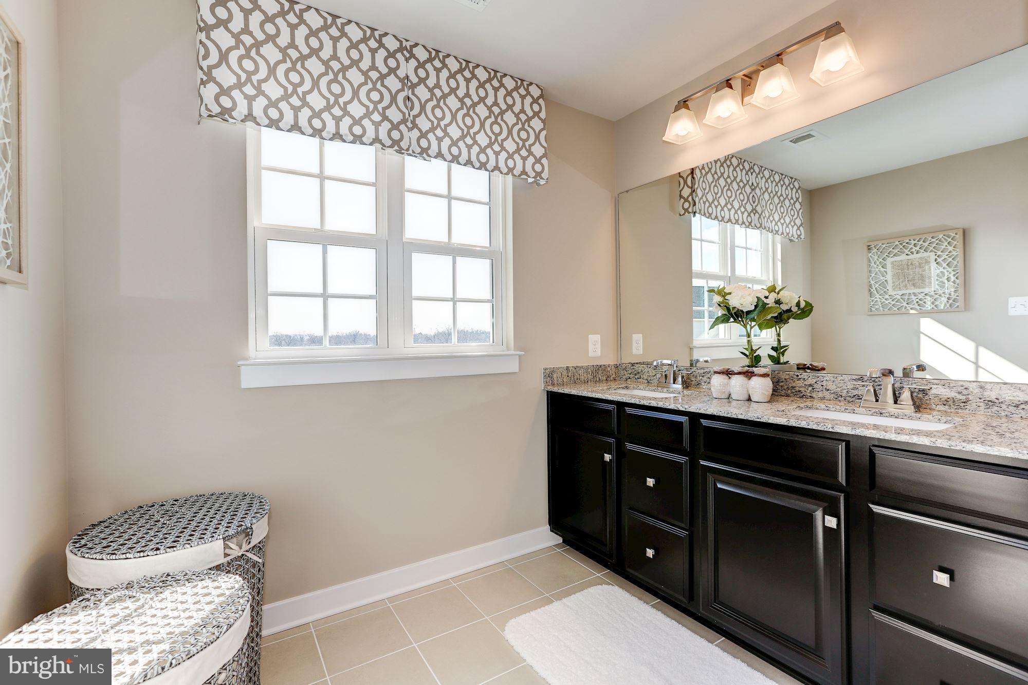 7641 Deepnotch Way Hanover, MD 21076 - Photo 11 of 25 a bathroom with a sink and a mirror