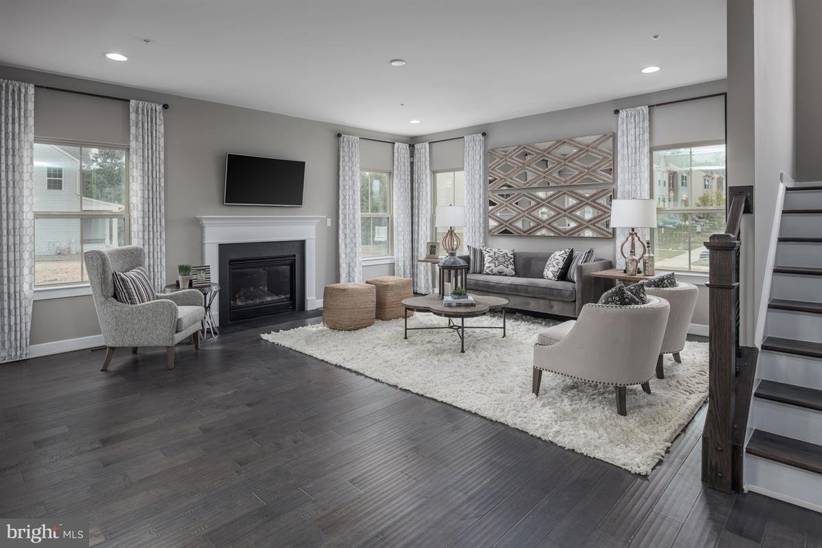 7641 Deepnotch Way Hanover, MD 21076 - Photo 5 of 25 a living room with furniture and a fireplace