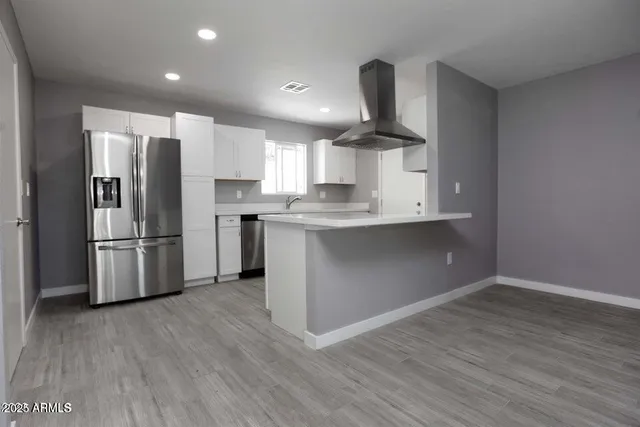 a kitchen with stainless steel appliances a refrigerator sink and microwave