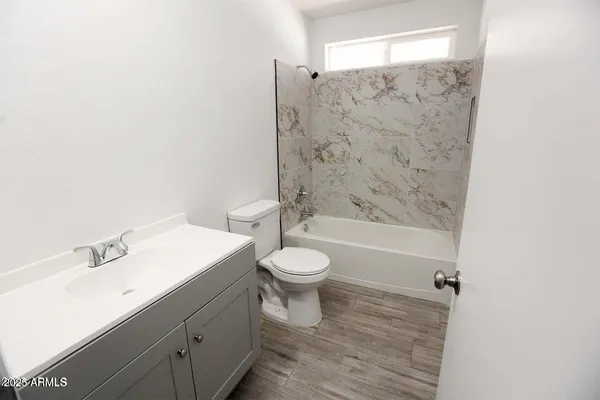a bathroom with a toilet a sink and a bathtub