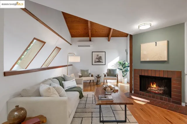a living room with furniture a fireplace and kitchen view