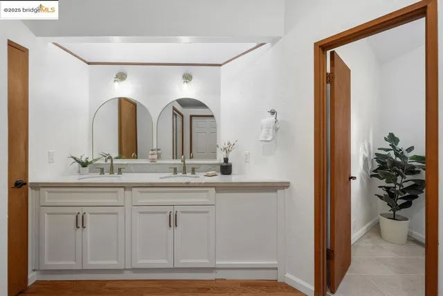 a living room with furniture and a painting on the wall