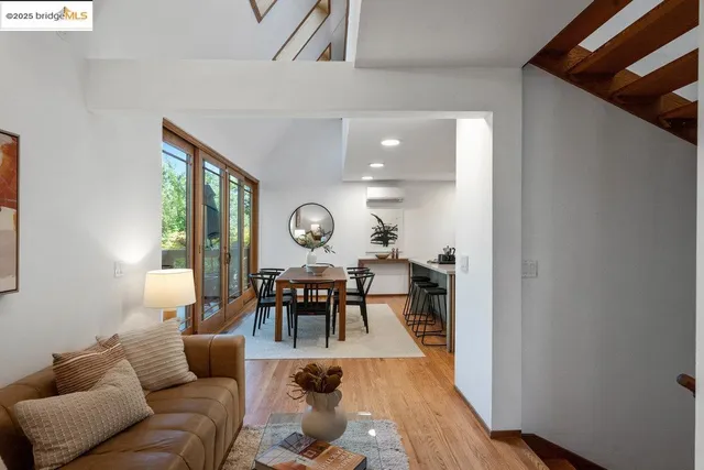 a living room with furniture kitchen view and a window