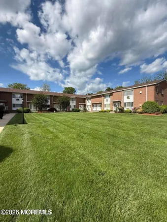a view of a field with lawn chairs and a yard