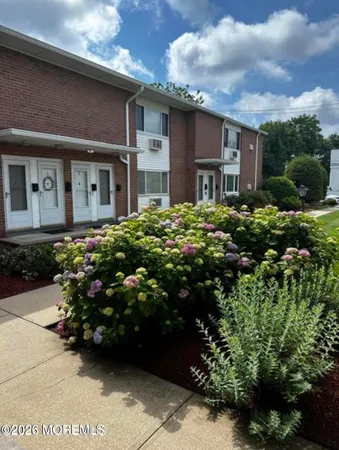 a view of a house with a flower garden