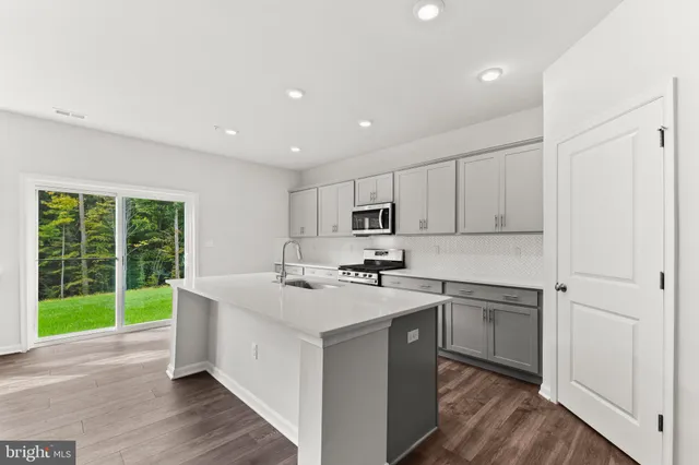 a kitchen with a sink stove and cabinets