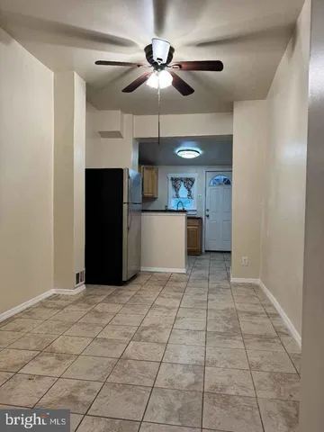 a view of kitchen with a sink and a refrigerator