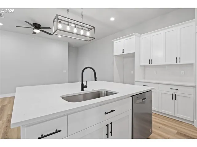 a view of a kitchen counter space a sink and dishwasher