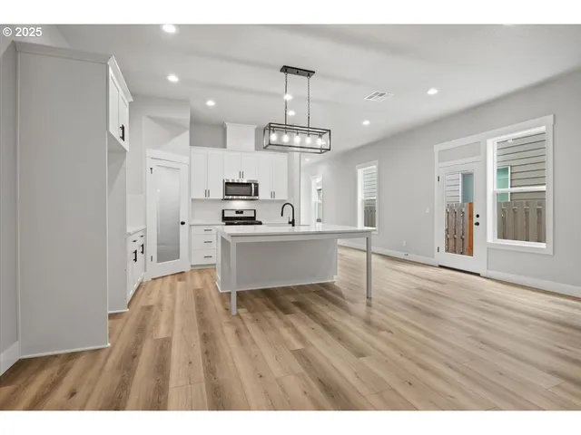 a kitchen with cabinets and a refrigerator