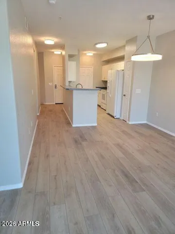 a view of a kitchen with a sink and a refrigerator