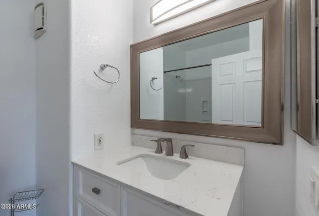 a bathroom with a sink and a mirror