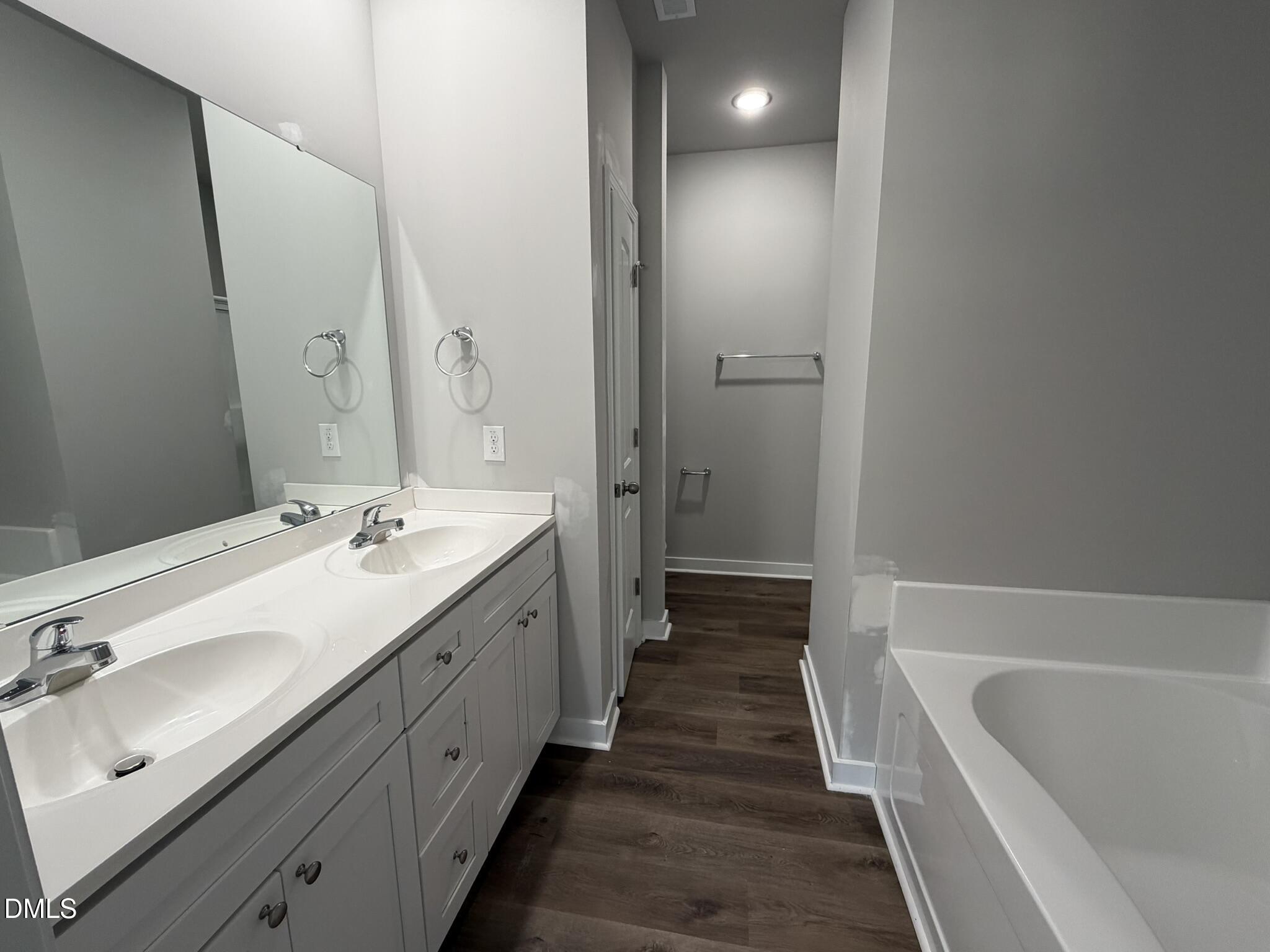 25 Jacobs Ridge Drive Four Oaks, NC 27524 - Photo 10 of 18 a bathroom with a double vanity sink and mirror with shower