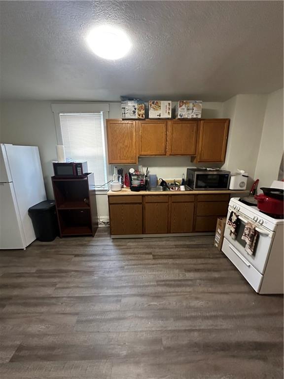 1131 12th Street McKees Rocks, PA 15136 - Photo 12 of 45 a view of a kitchen with kitchen island a sink wooden floor and a large window