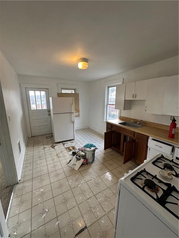 1131 12th Street McKees Rocks, PA 15136 - Photo 22 of 45 a kitchen with granite countertop a stove and a sink
