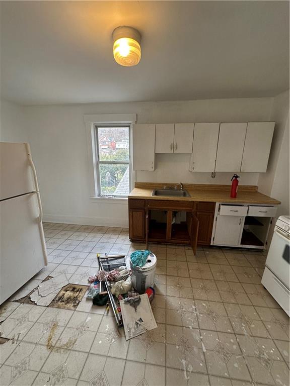 1131 12th Street McKees Rocks, PA 15136 - Photo 24 of 45 a kitchen with a sink a stove and cabinets
