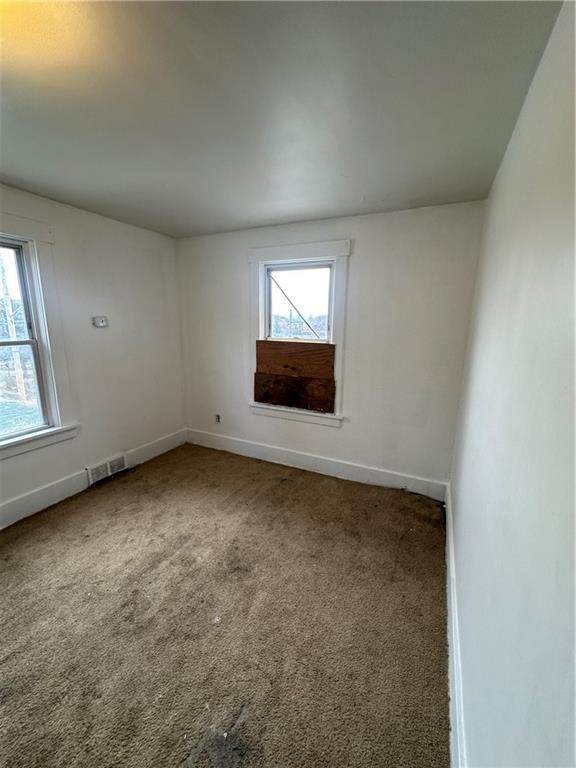 1131 12th Street McKees Rocks, PA 15136 - Photo 28 of 45 an empty room with a fireplace and windows