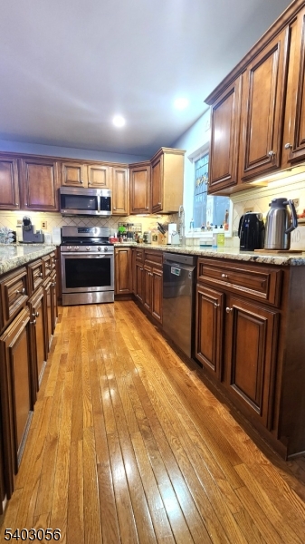 52 Fox Hollow Road Montague, NJ 07827 - Photo 14 of 45 a kitchen with kitchen island granite countertop wooden cabinets stainless steel appliances and a window